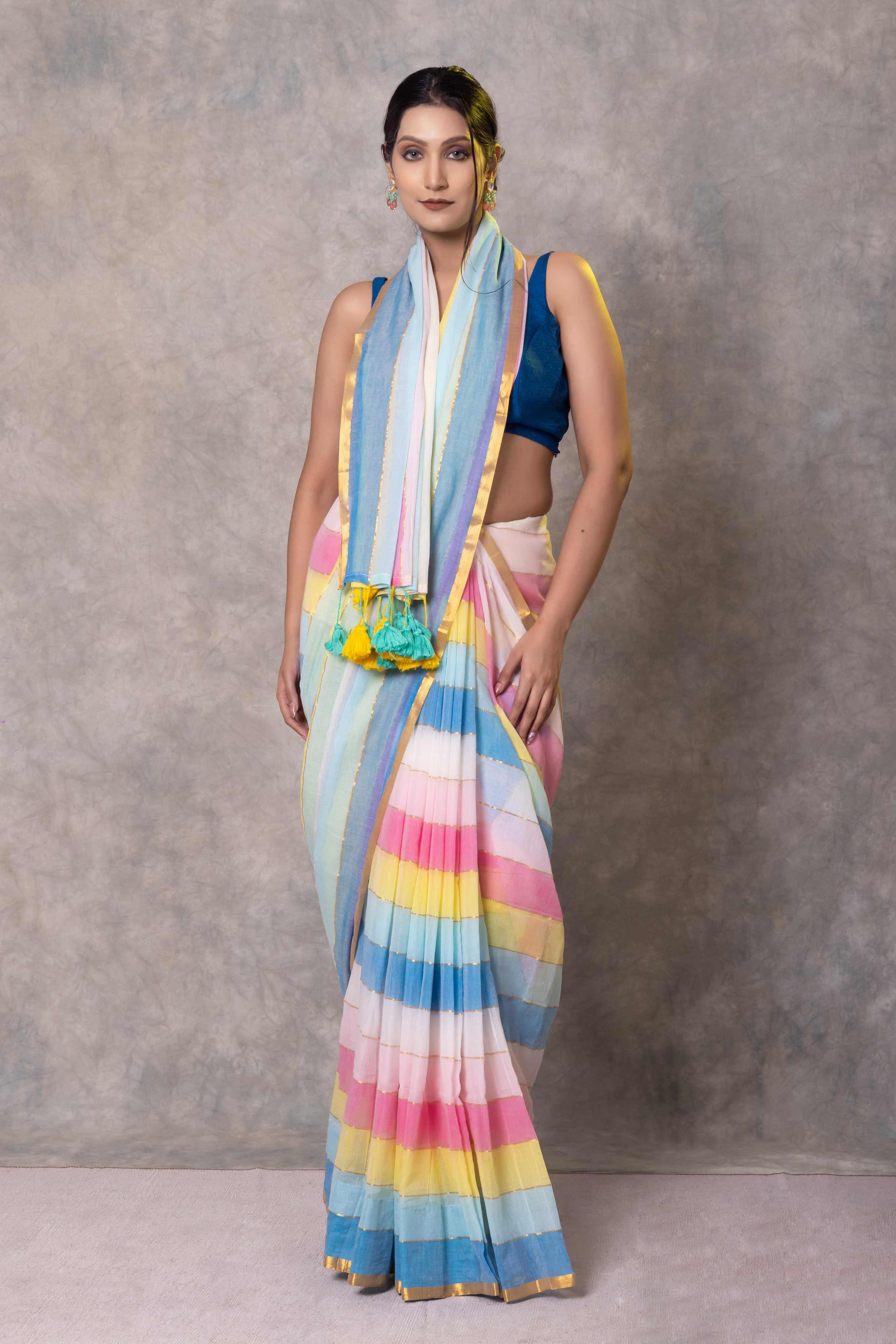 Woman wearing a colorful striped saree with a plain background