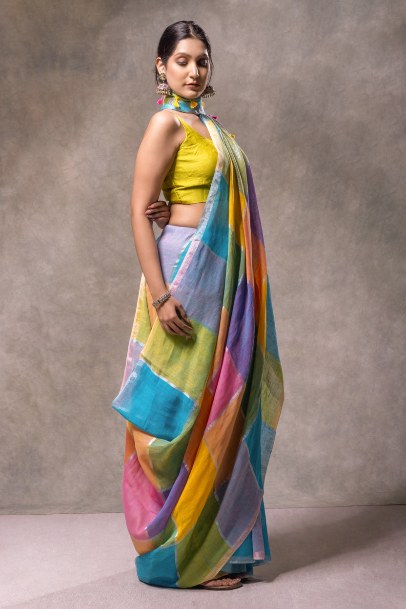 Woman wearing a colorful saree with a neutral background