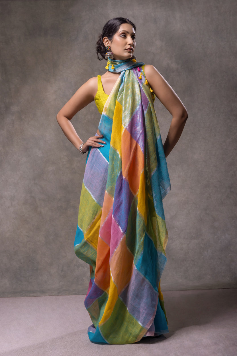 Woman wearing a colorful scarf draped over her shoulders against a gray background