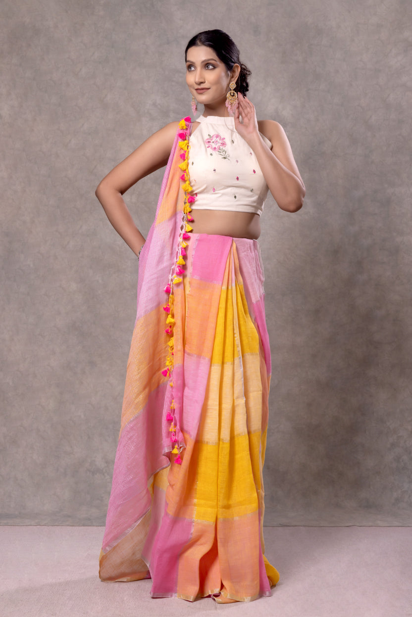 Woman wearing a colorful saree with a plain background