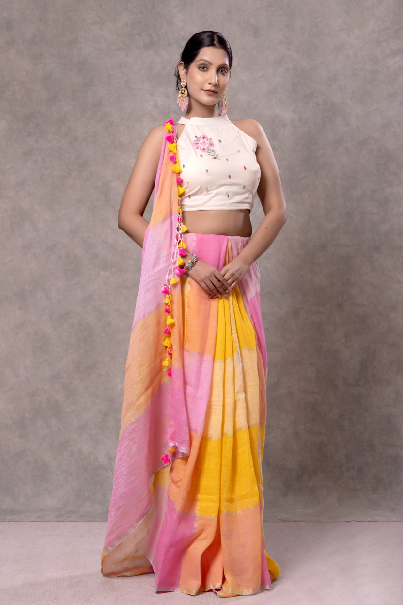 Woman wearing a colorful saree with a plain background