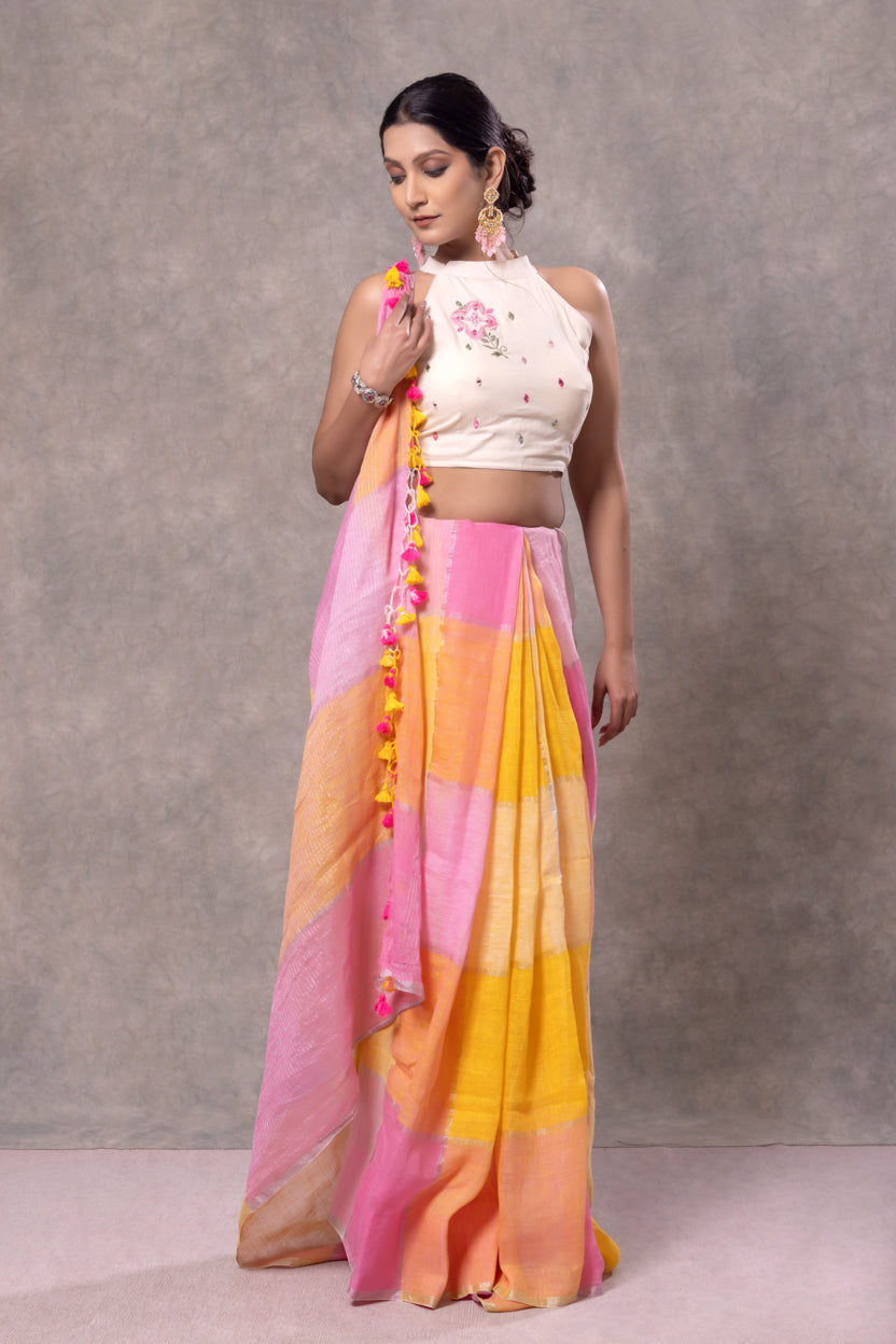 Woman wearing a colorful saree with a plain background