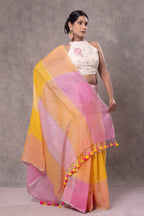 Woman wearing a colorful saree with a plain background
