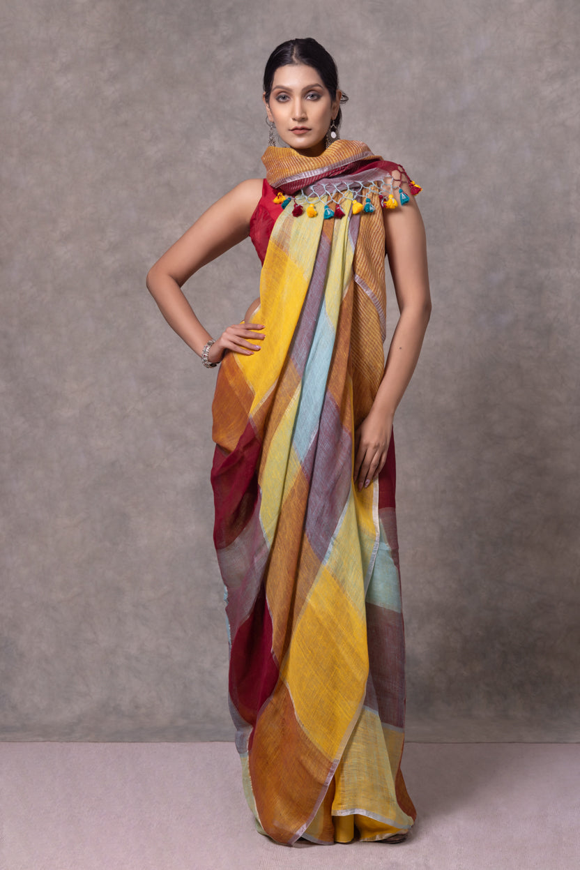Woman wearing a colorful saree with a plain background