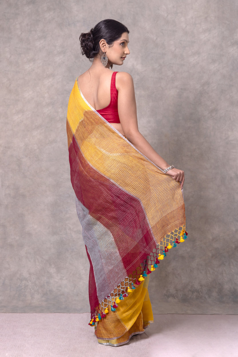 Woman wearing a colorful saree with a textured pattern against a gray background