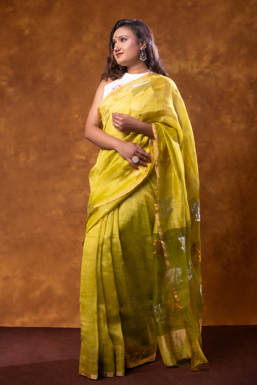 Woman wearing a yellow saree against a brown background