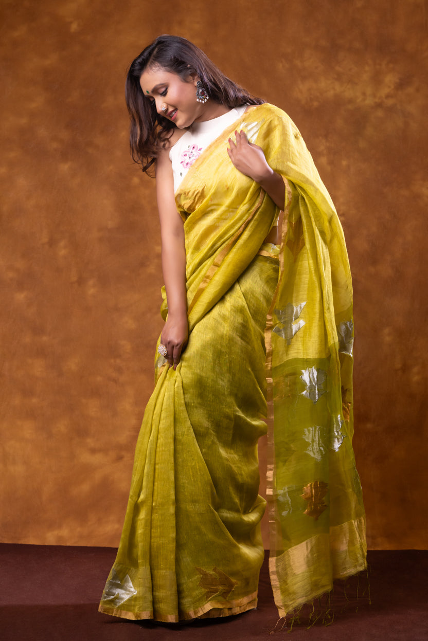 Woman wearing a yellow saree with a brown background