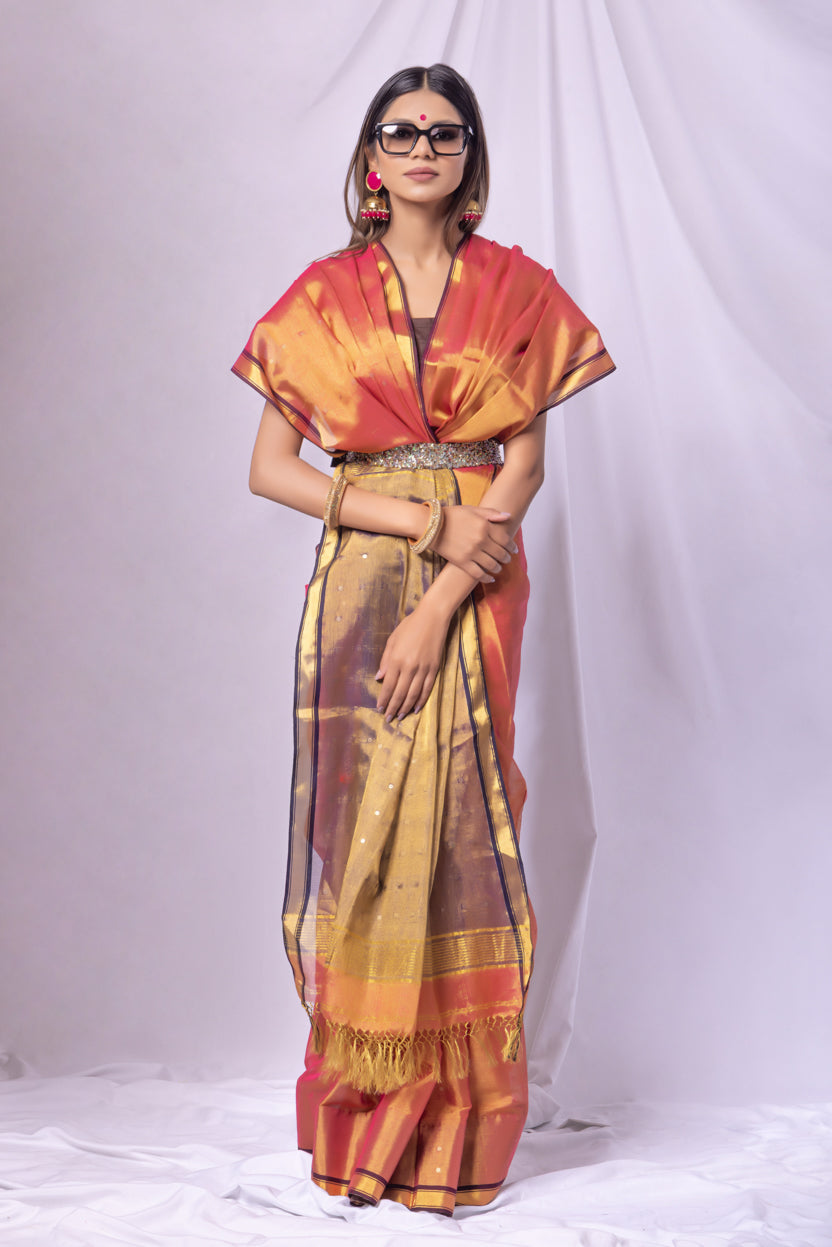 Woman wearing a traditional outfit with a colorful saree and blouse on a white background