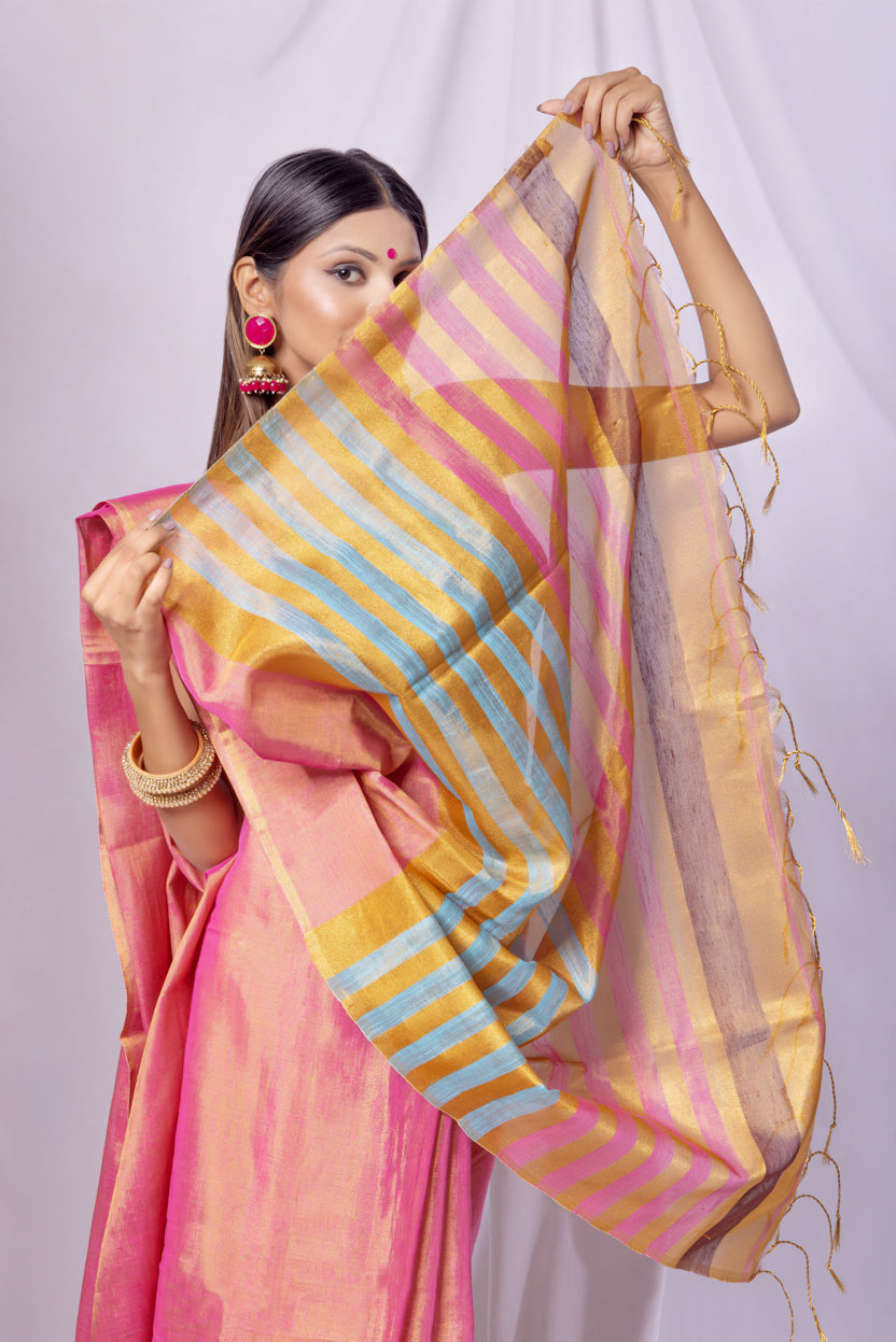 Woman holding a colorful striped fabric against a plain background