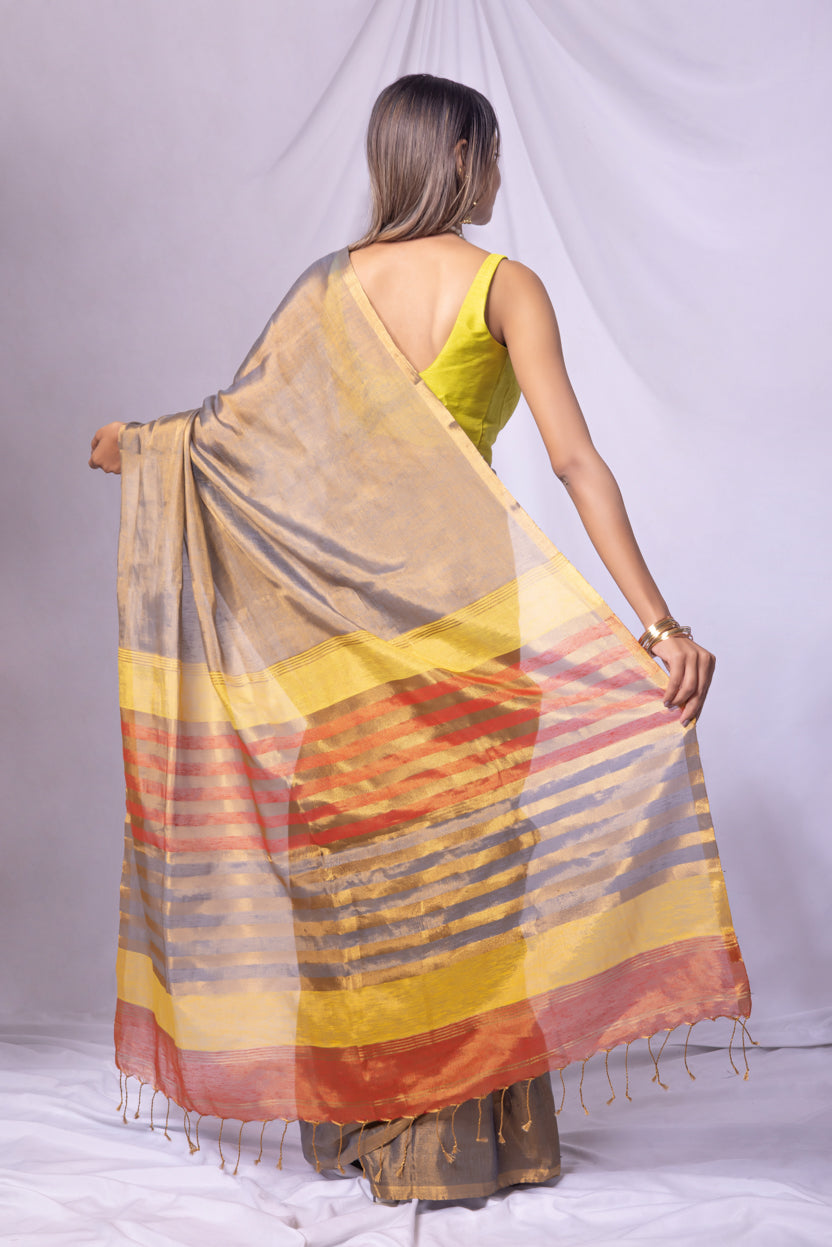 Woman wearing a colorful saree with a plain background