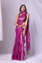 Woman wearing a vibrant pink saree with a white background