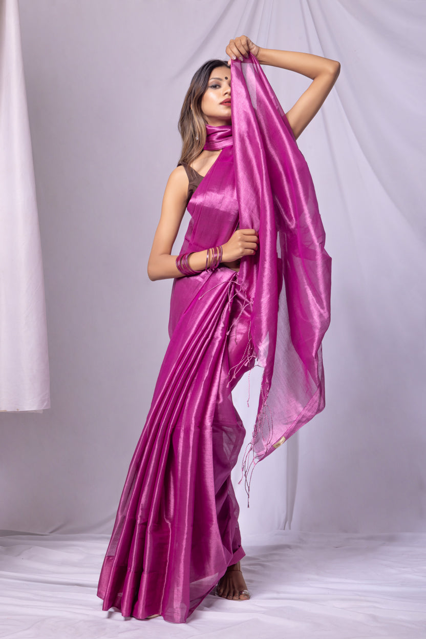 Woman wearing a pink saree with a white background