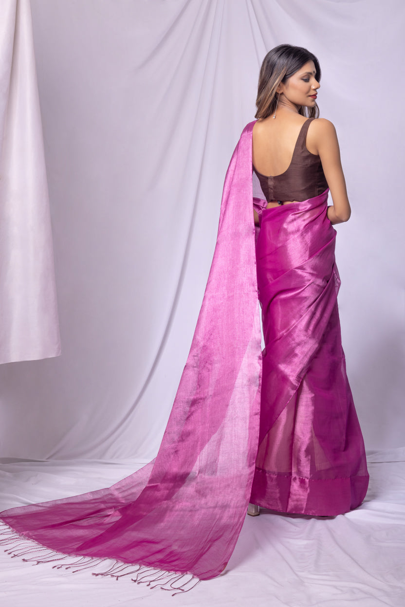 Woman wearing a pink saree with a white background