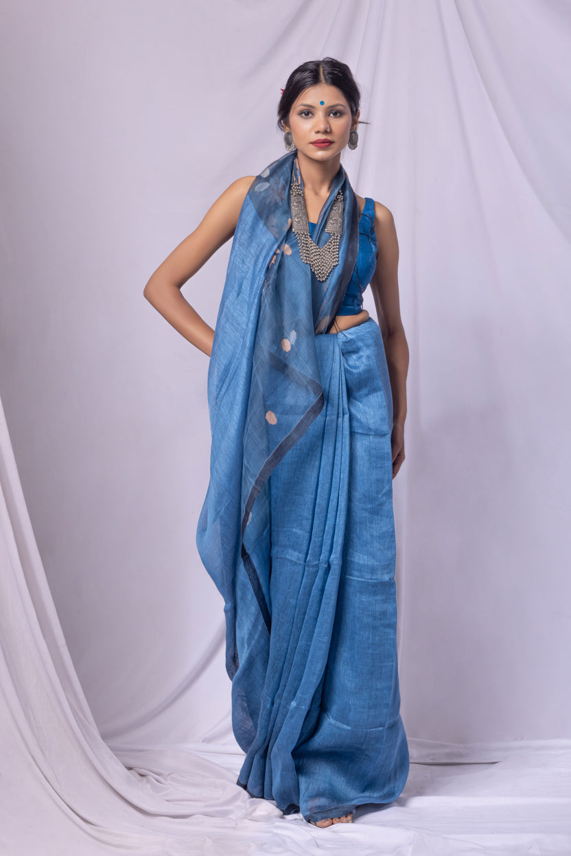 Woman wearing a blue saree with a white background
