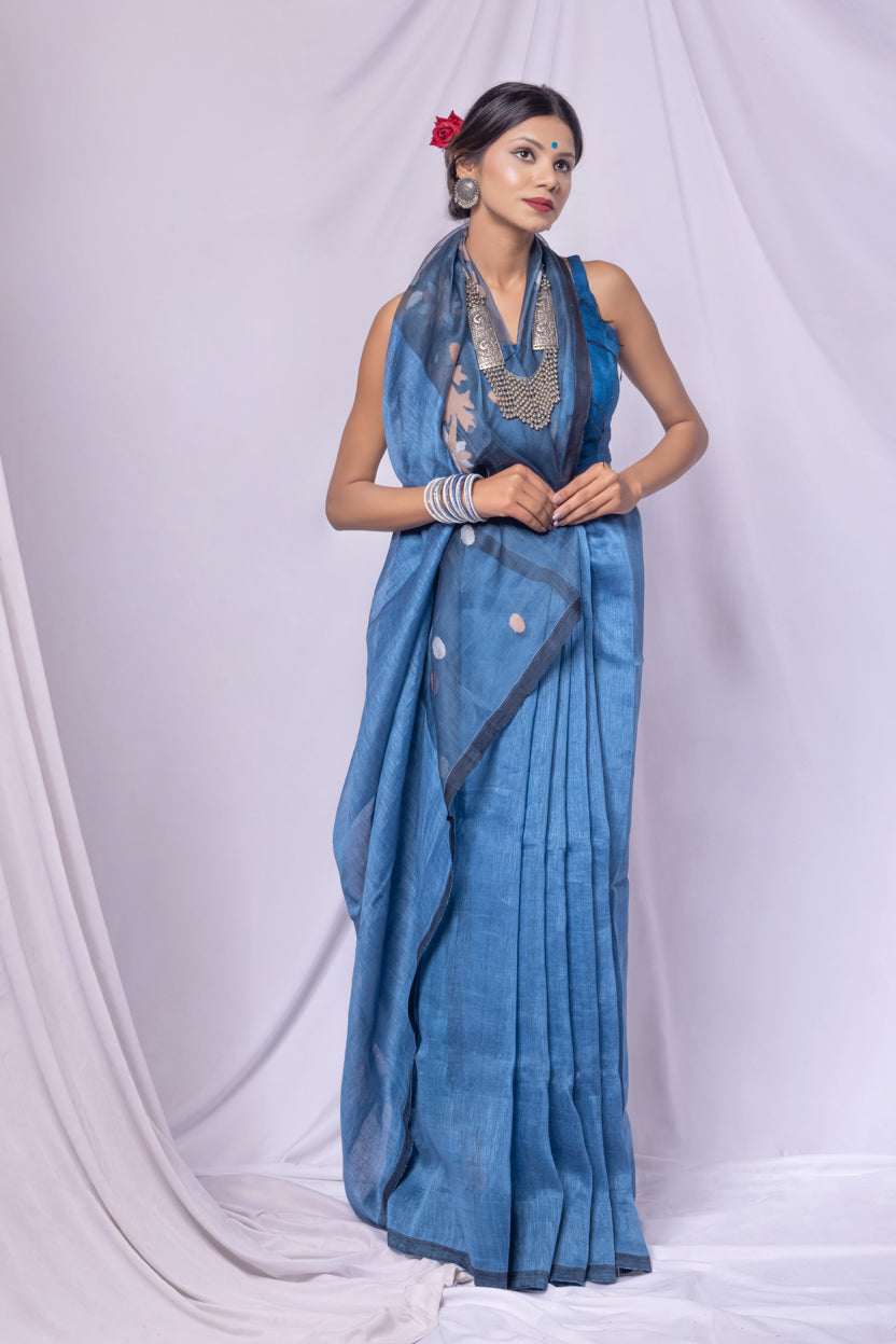Woman wearing a blue saree with a white background