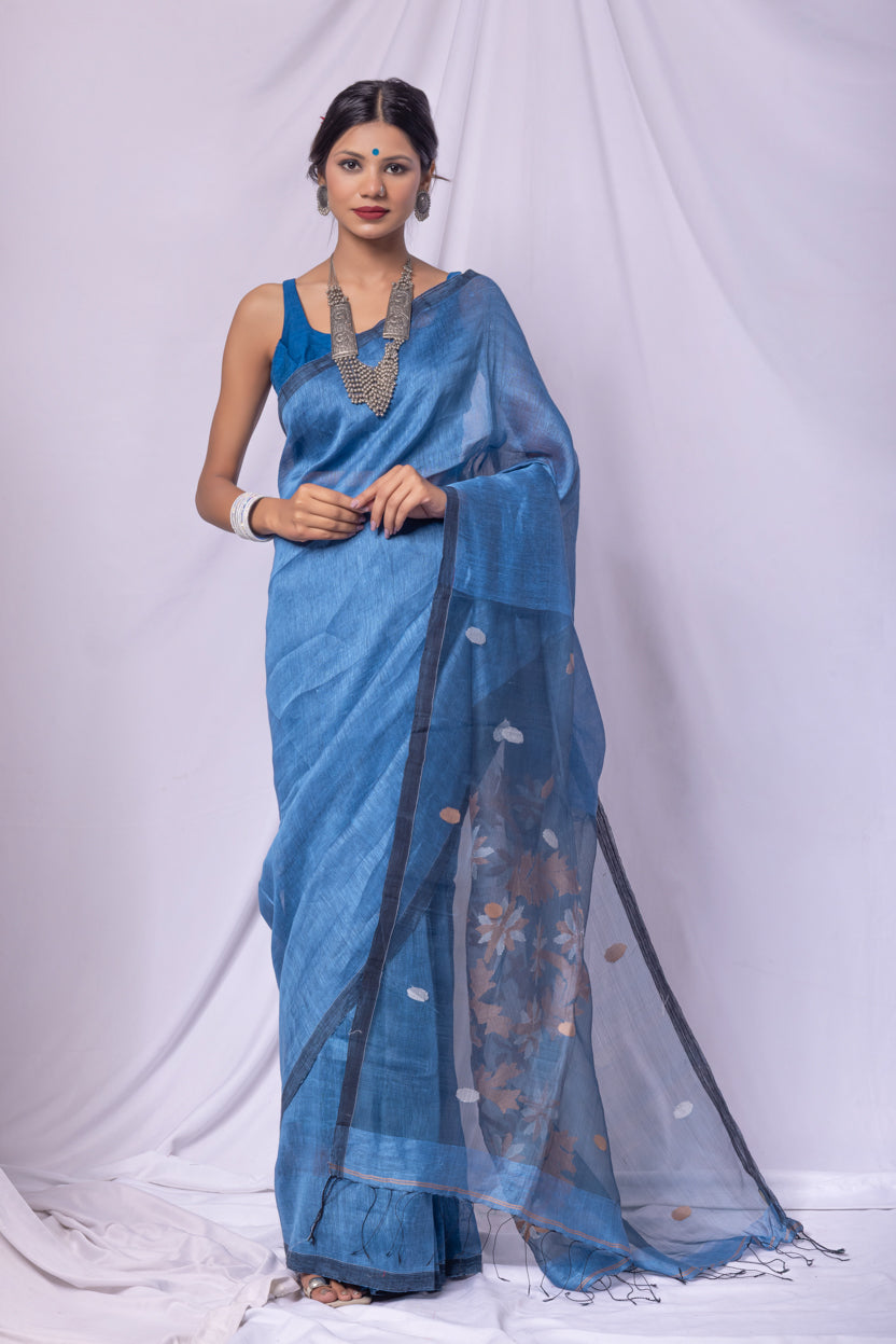 Woman wearing a blue saree with a white background