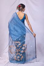Woman wearing a blue saree with a white background