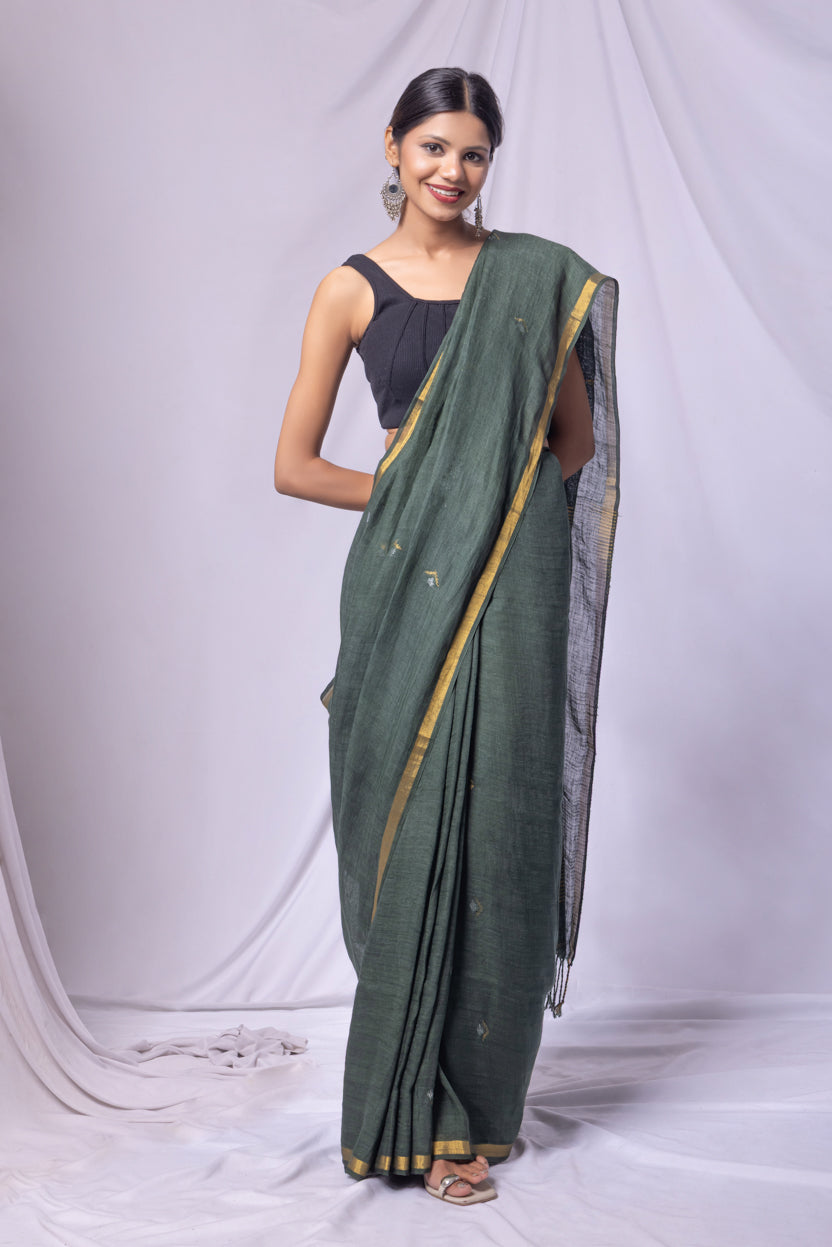Woman wearing a green saree with a white background