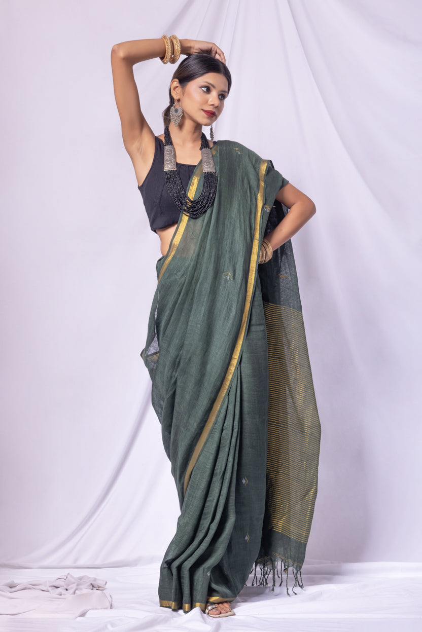 Woman wearing a green saree with a white background