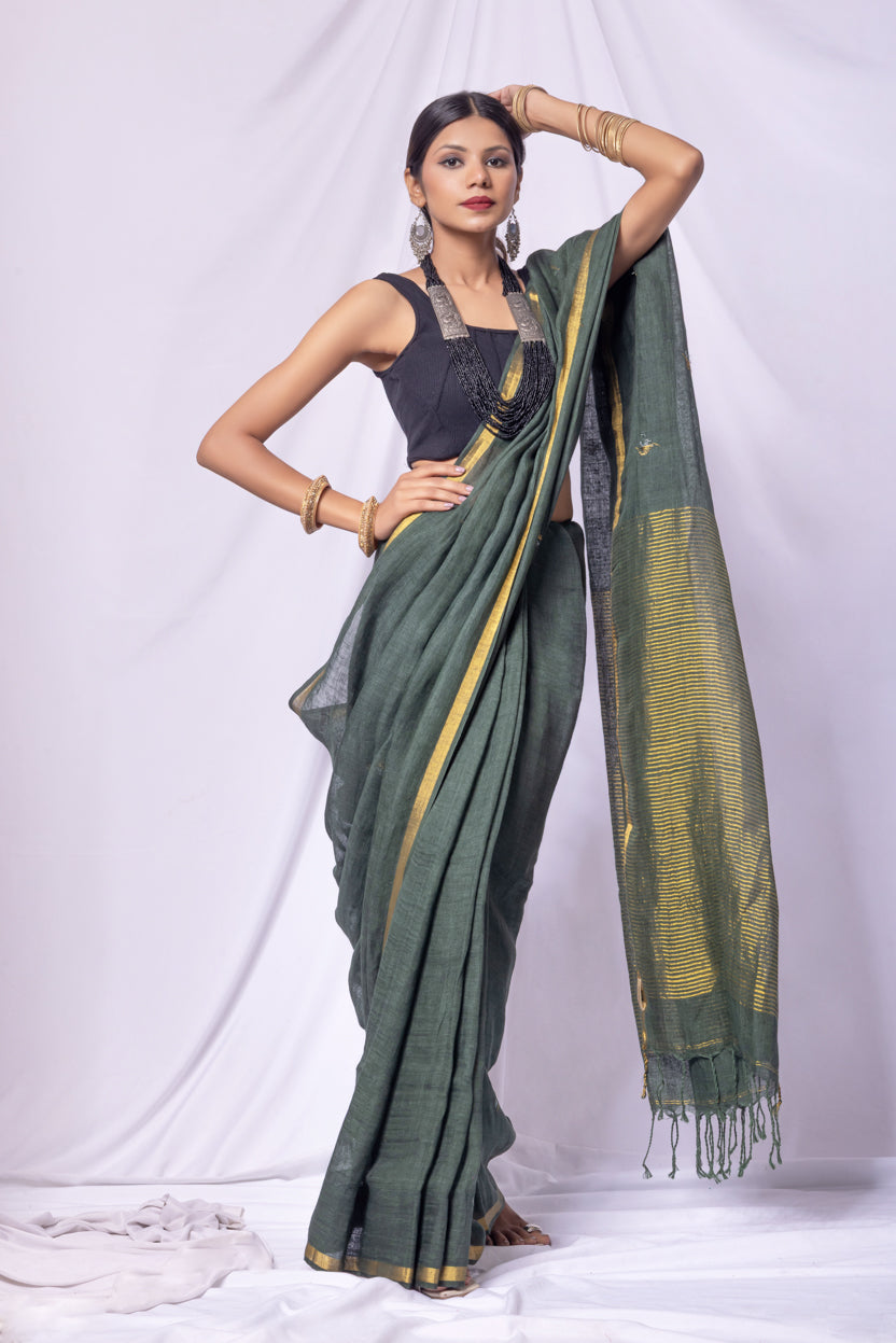Woman wearing a green saree with a white background